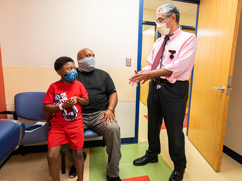 Dr. Makram Ebeid talks with Levi D'Anjou II and his father, Levi D'Anjou Sr.